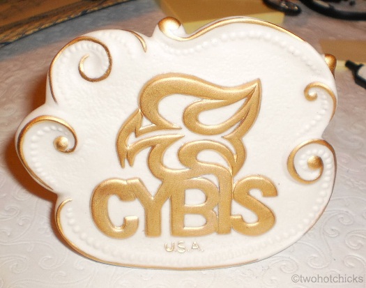 Cybis freeform dealer sign matte gold on white 1990s